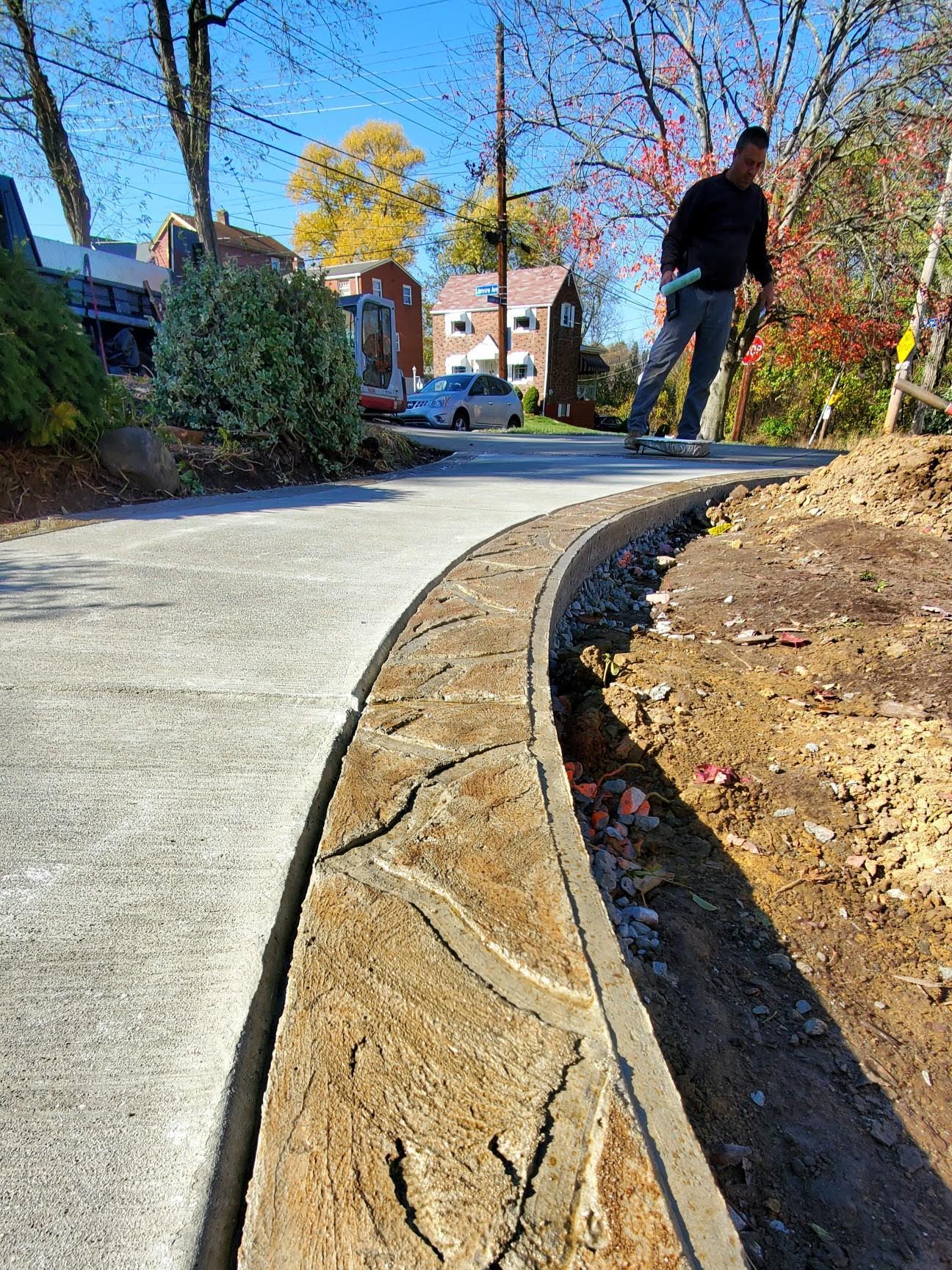 A man standing on the side of a road.