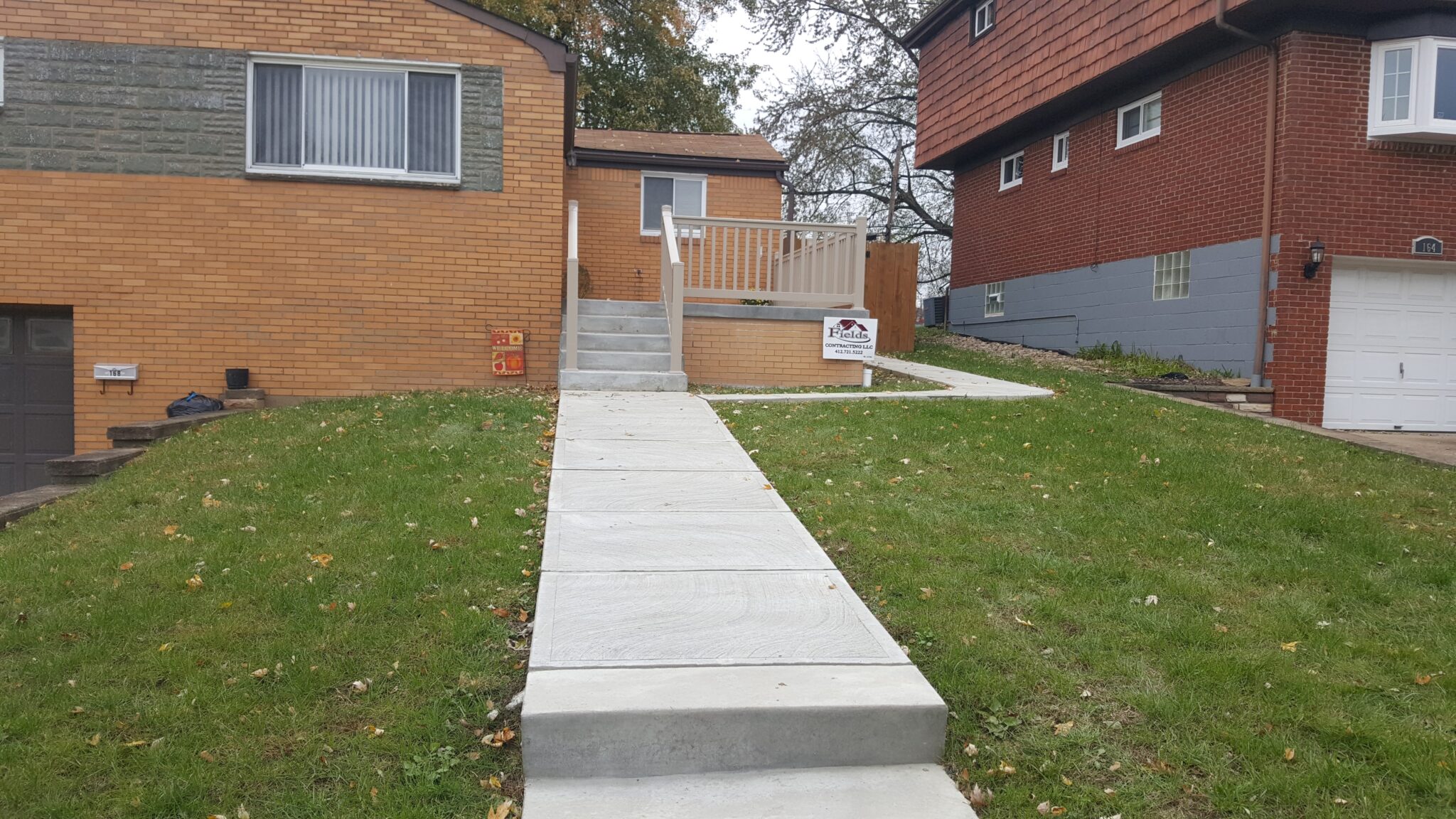 A walkway with steps leading to the front yard.