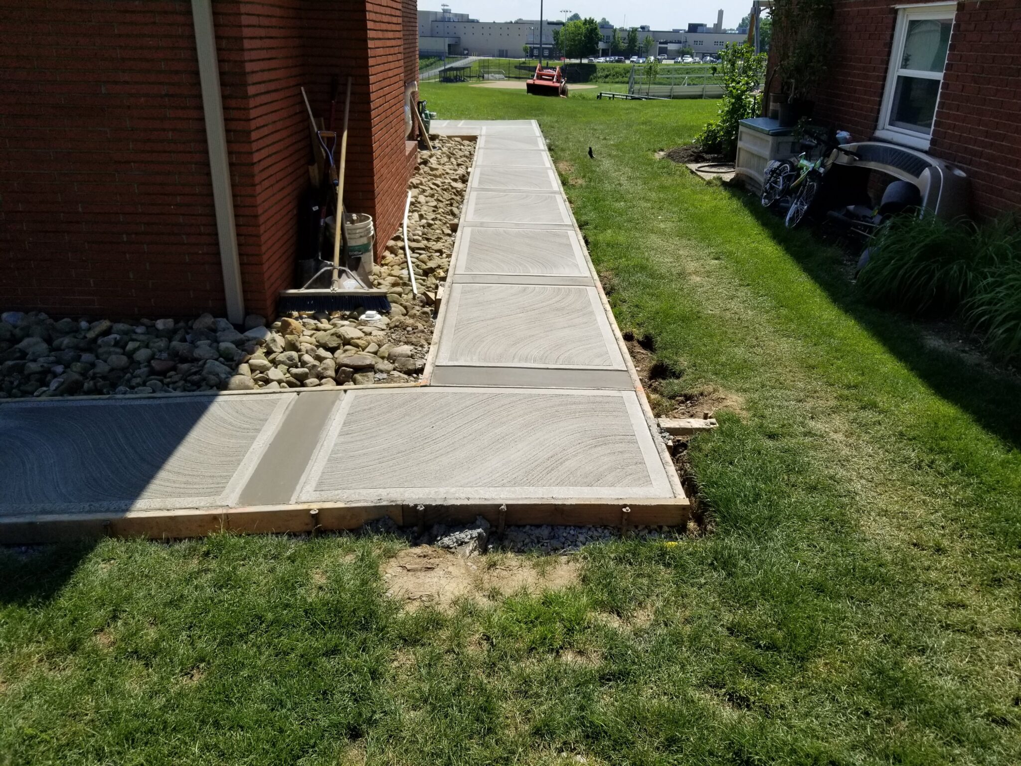A walkway that is being built in the grass.