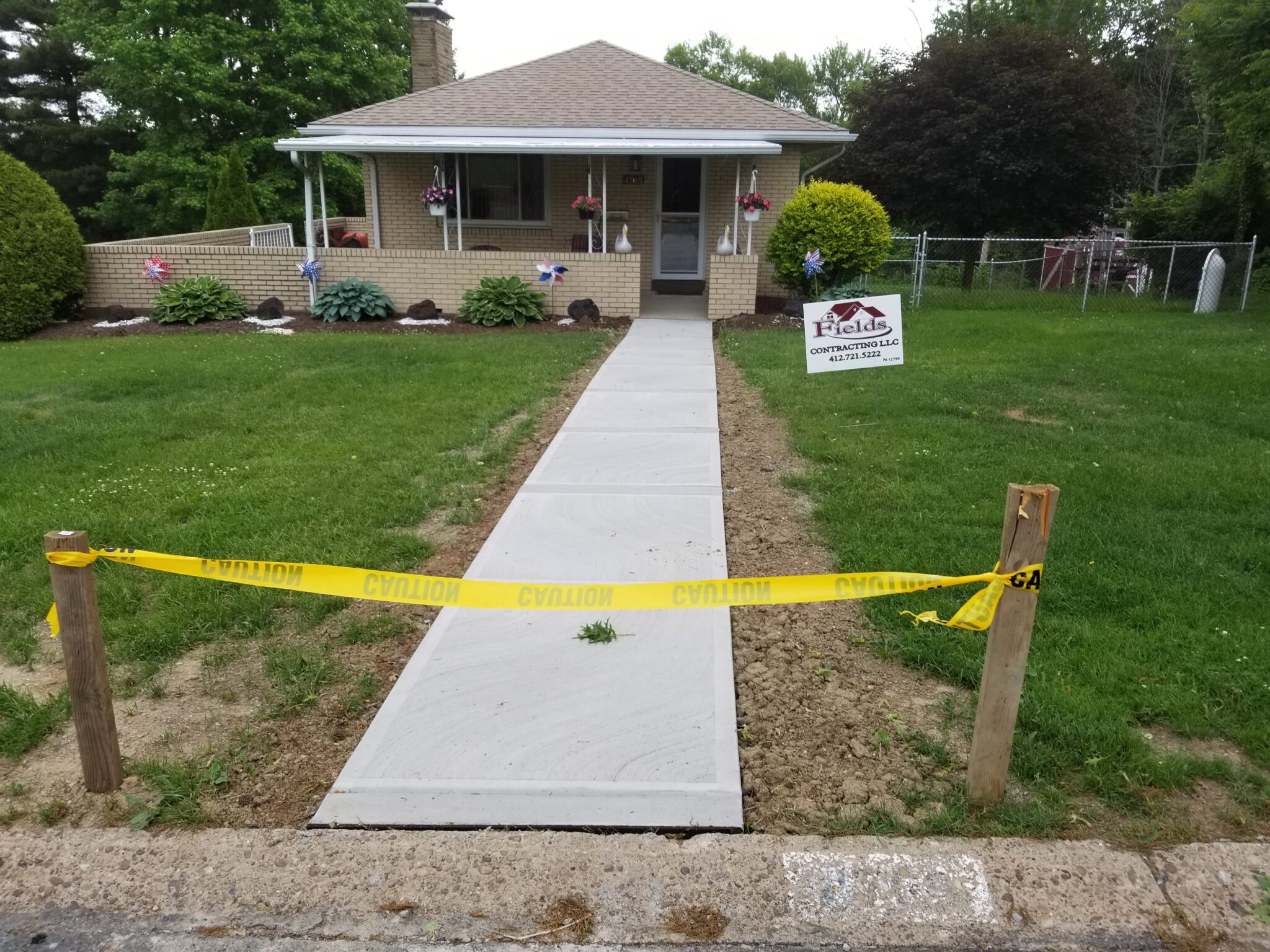 A yellow tape is taped off around the sidewalk.