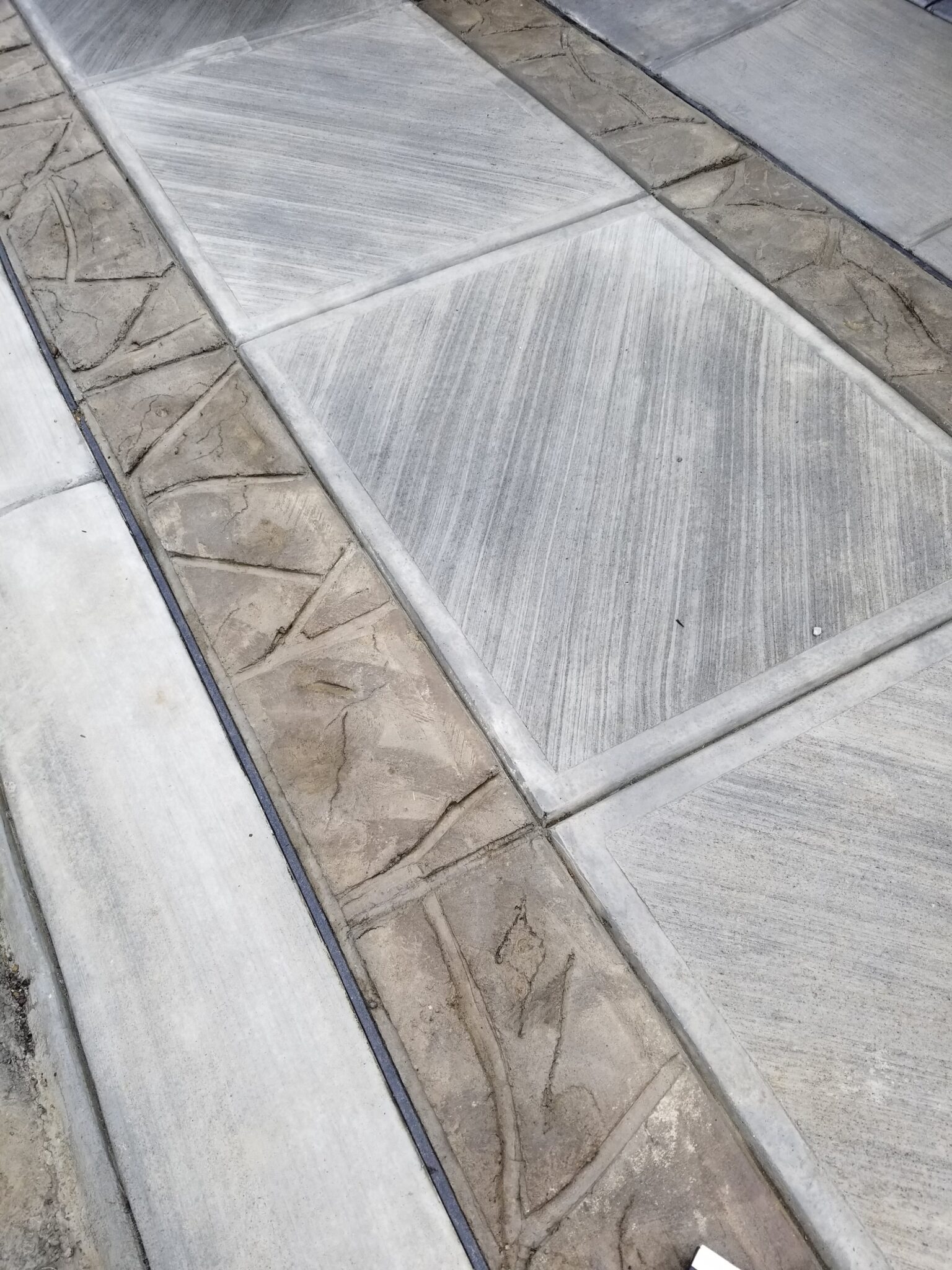 A close up of the floor with cement and wood