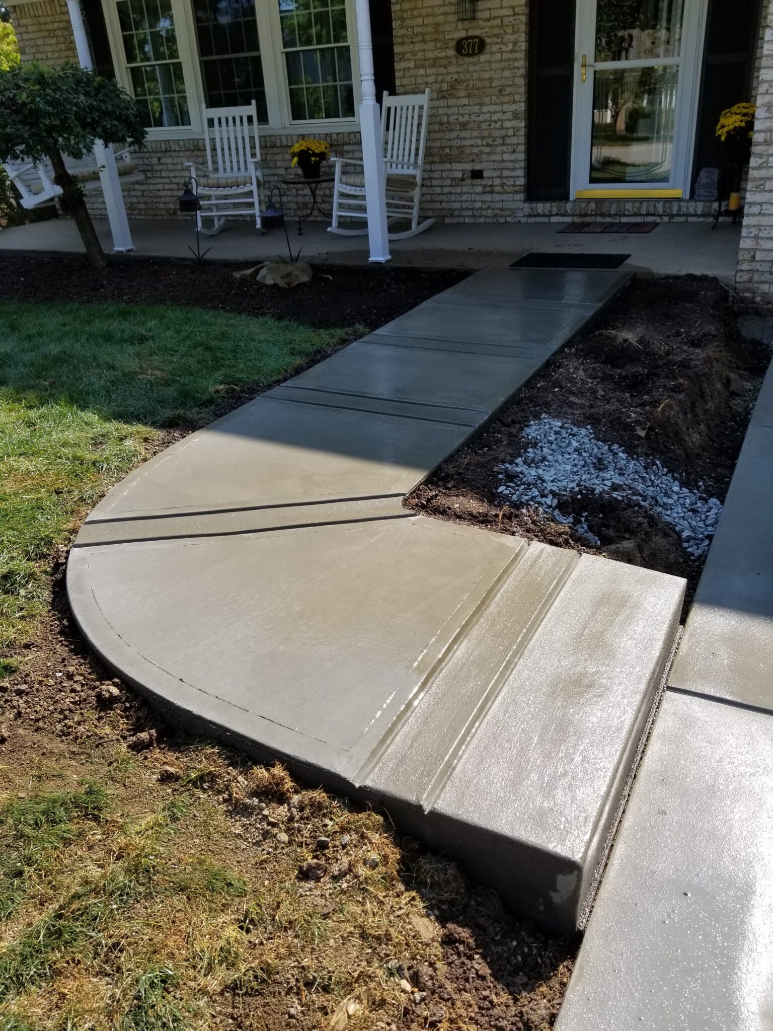 A walkway with concrete steps and gravel.