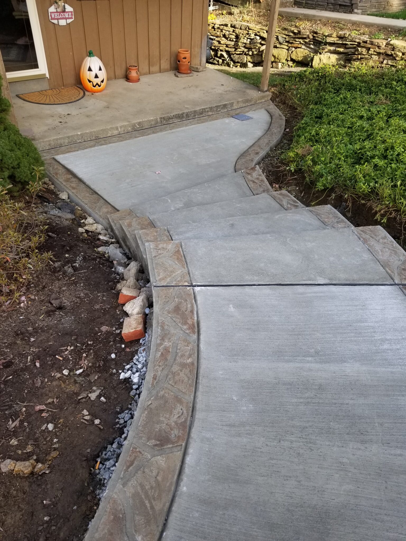 A walkway with concrete steps and decorative border.