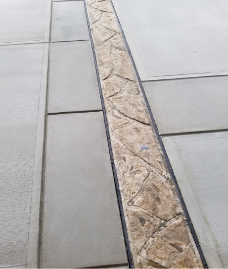 A close up of the edge of a tile floor