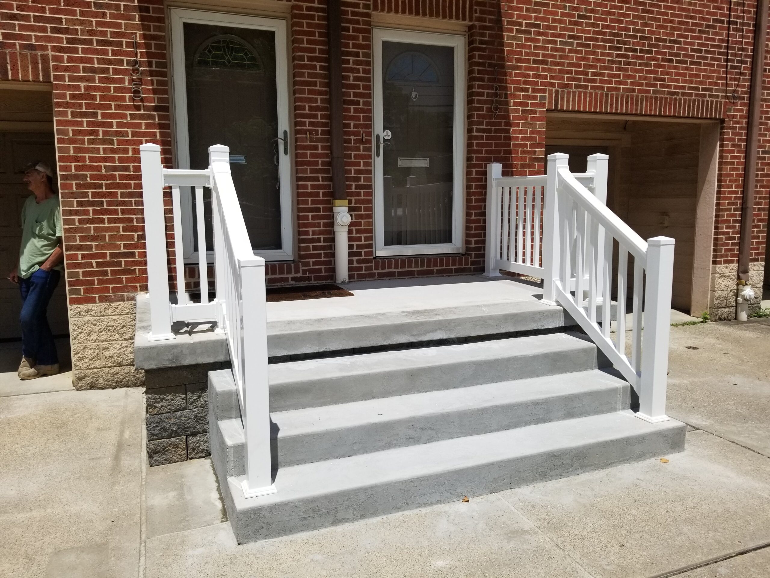 20210702_135338 A white staircase with steps leading to the front door.