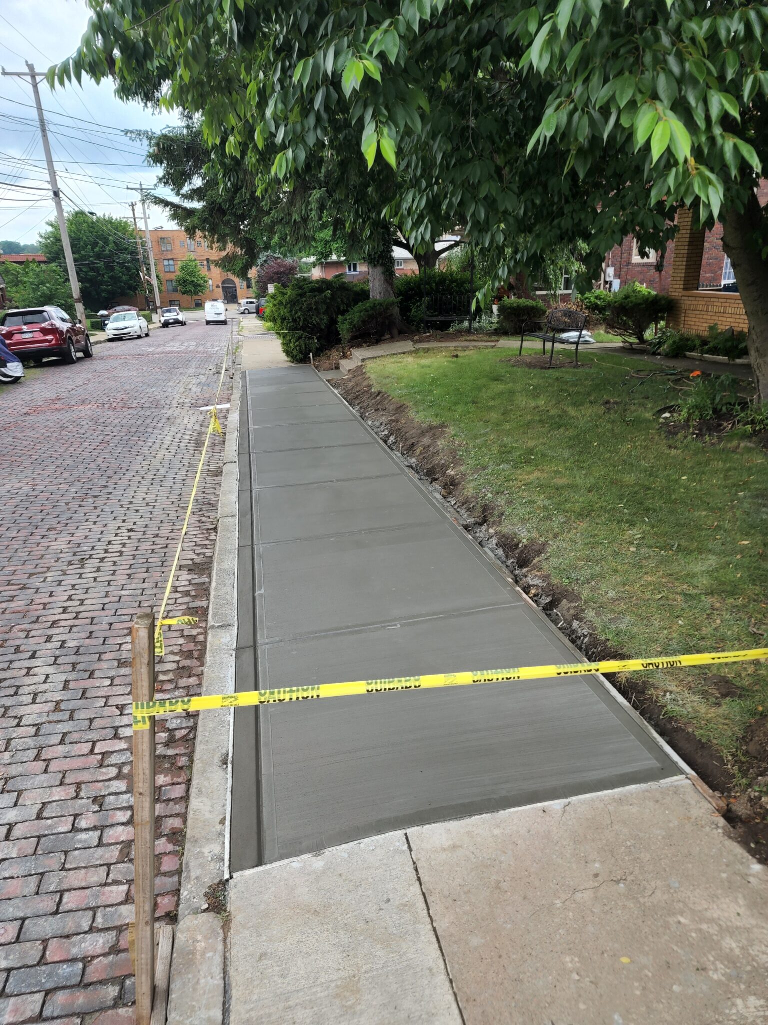 A sidewalk with yellow tape on it