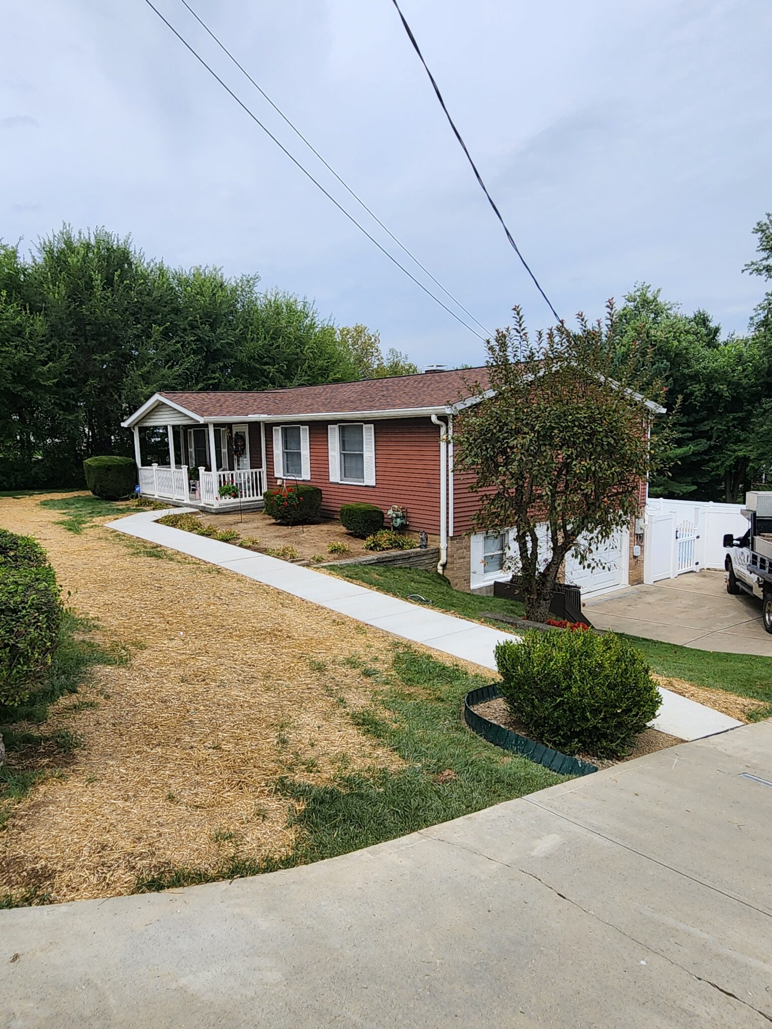 A house with a driveway and garage in the back.