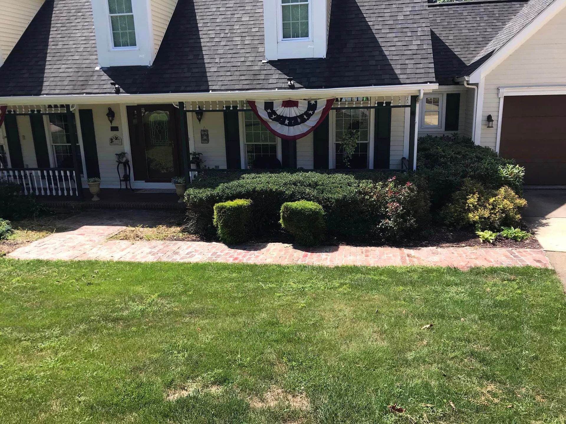 A house with a flag on the front yard.