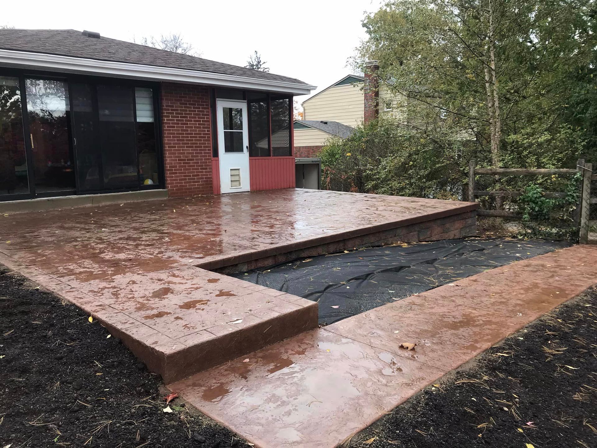314945794_1996780713858512_381994289464605296_n-1920w A brick patio with steps leading to the back deck.