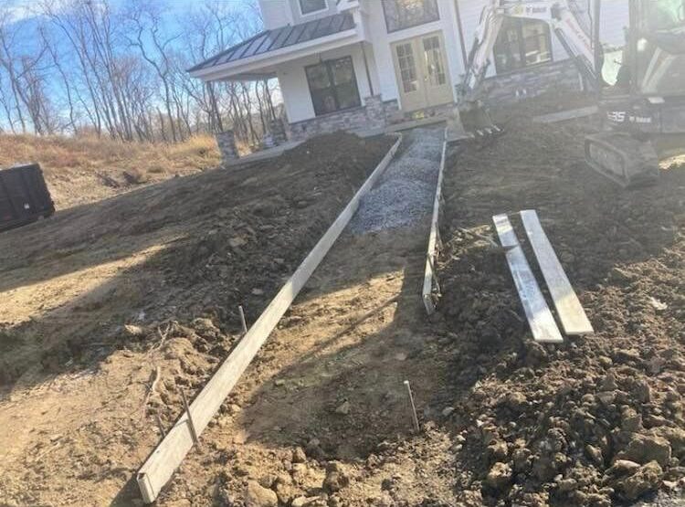 A house with some concrete steps in the dirt