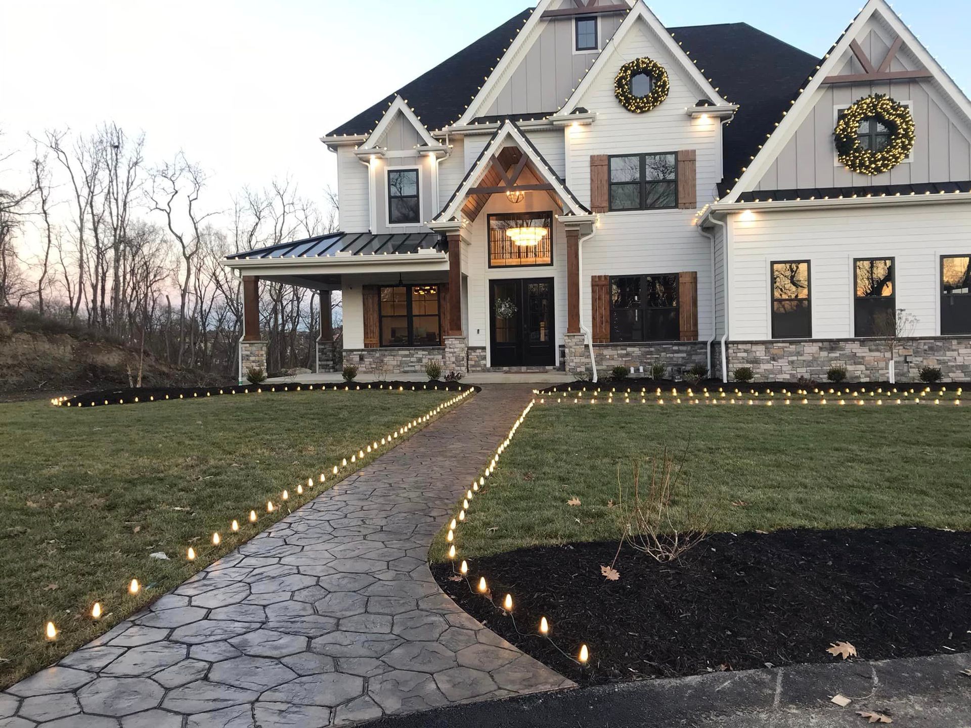 A house with a walkway and lawn in front of it