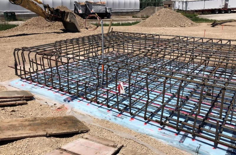 A construction site with metal rods being used to build a floor.