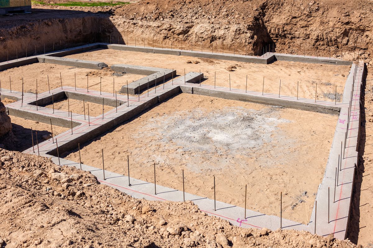 A concrete slab with some metal posts and wires