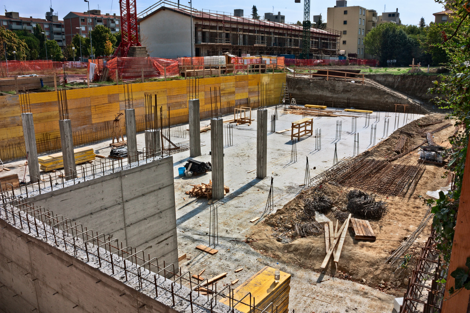 A construction site with many concrete blocks and metal poles.