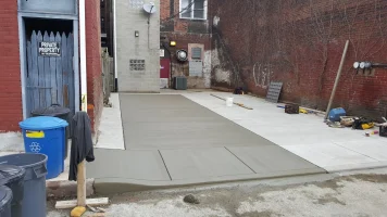 A sidewalk that has been laid out and is being poured.