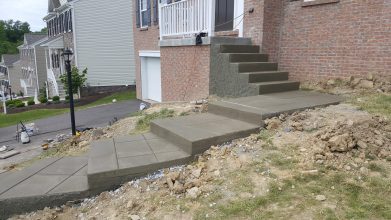 A concrete staircase in front of a house.