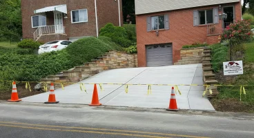 A street with orange cones and yellow tape on the side of it.