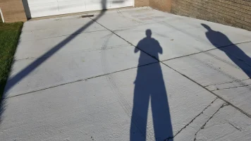 A person is standing in the shadow of a door.