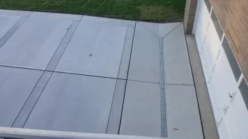 A patio with a sidewalk that has been cut in half.