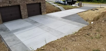 A driveway with concrete steps and a garage door.