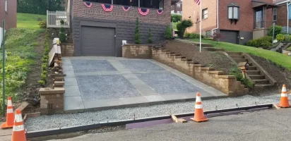 A parking lot with a cement block driveway.