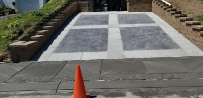 A street with a orange cone on the sidewalk