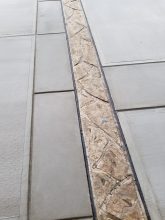 A close up of the floor with a tile border