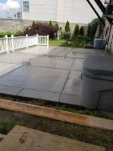 A patio with a bench and table in it