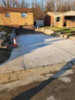 A concrete driveway that has been laid in the middle of it.