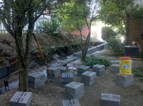 A bunch of concrete blocks are in the dirt