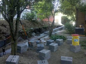 A bunch of concrete blocks are in the dirt