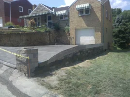 A house with a concrete slab in front of it.