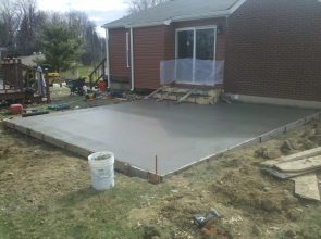 A cement slab is being poured for the patio.