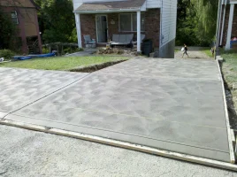 A driveway with concrete in the middle of it