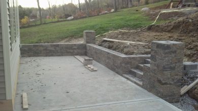A concrete patio with steps and stairs in the middle of it.