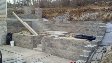 A stone wall being built with steps and stairs.