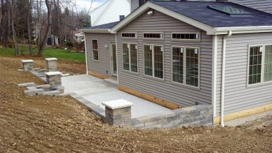 A house with concrete steps and a stone walkway.