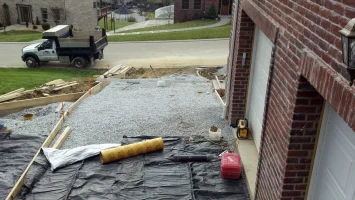 A driveway being built with concrete and plastic sheeting.