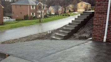 A concrete walkway with steps leading to the top of it.